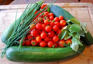 Arrangement of vegetables and herbs awaiting to be cooked.