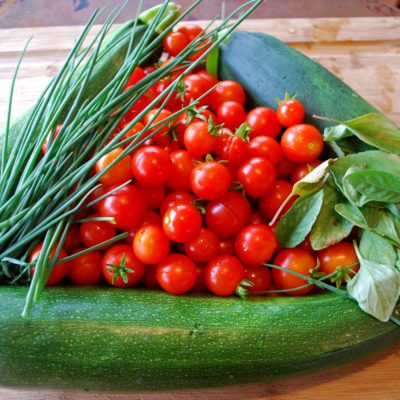 Arrangement of vegetables and herbs awaiting to be cooked.