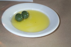 A pair of olives in olive oil